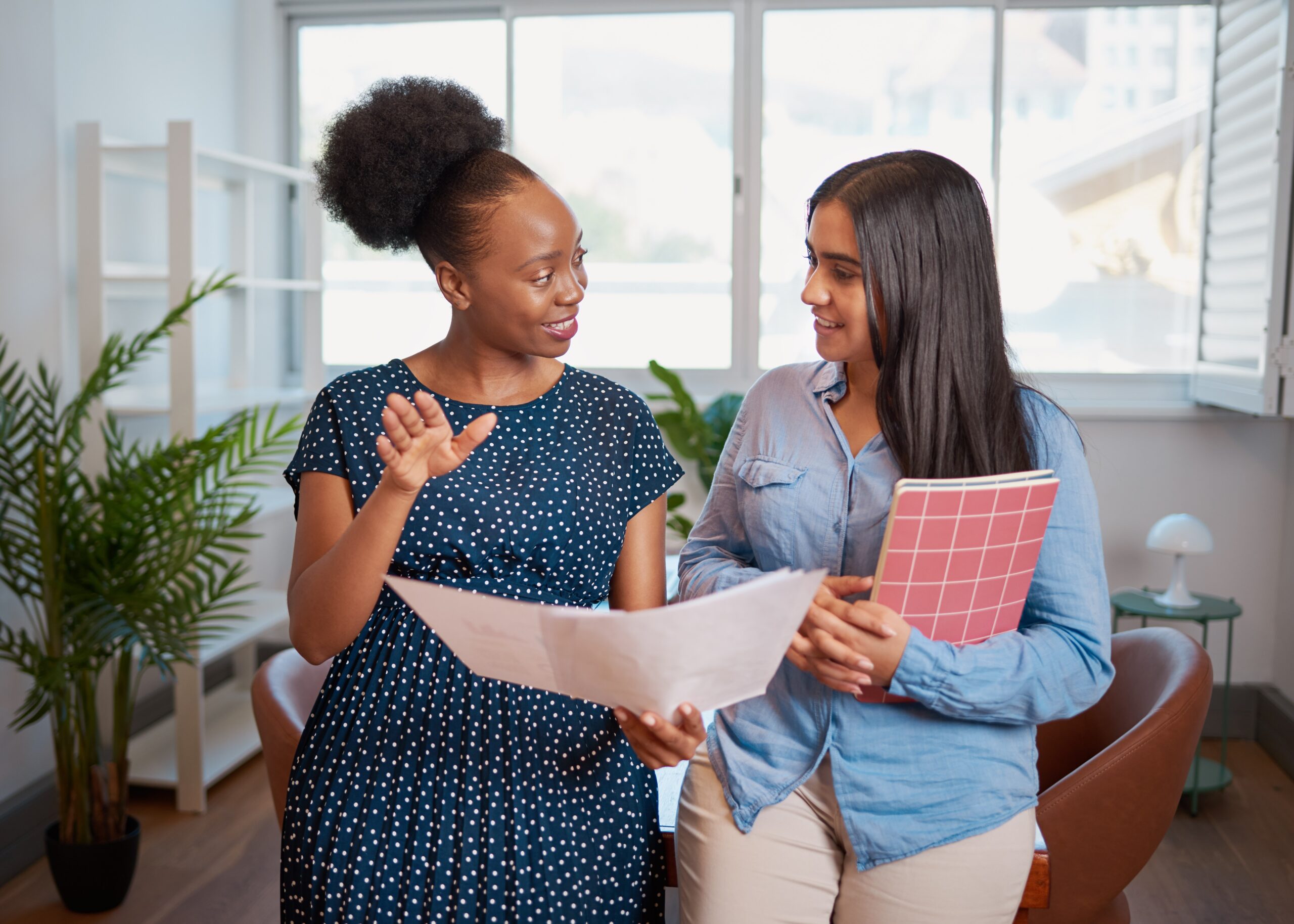 A seasoned professional conducting a peer mentorship with a new hire.